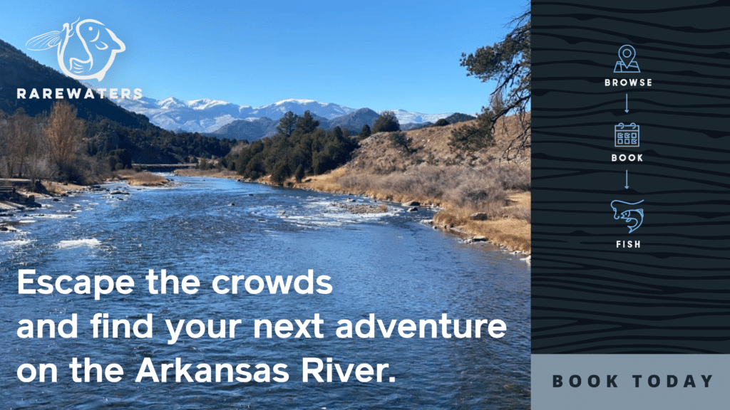 A beautiful scene on the Arkansas River in Colorado with snow-capped mountains in the background.